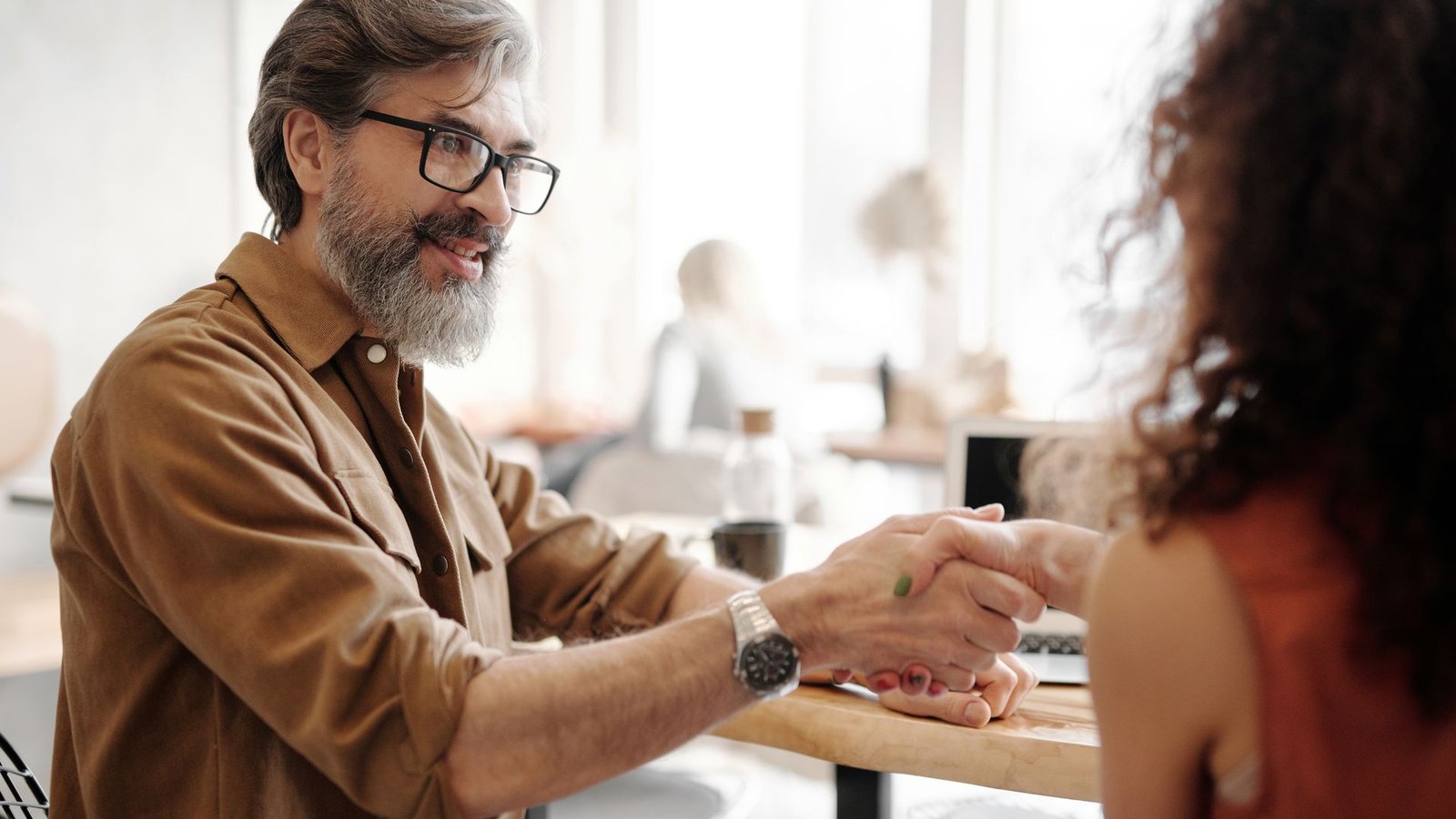 Accountant shaking hands with a satisfied business client
