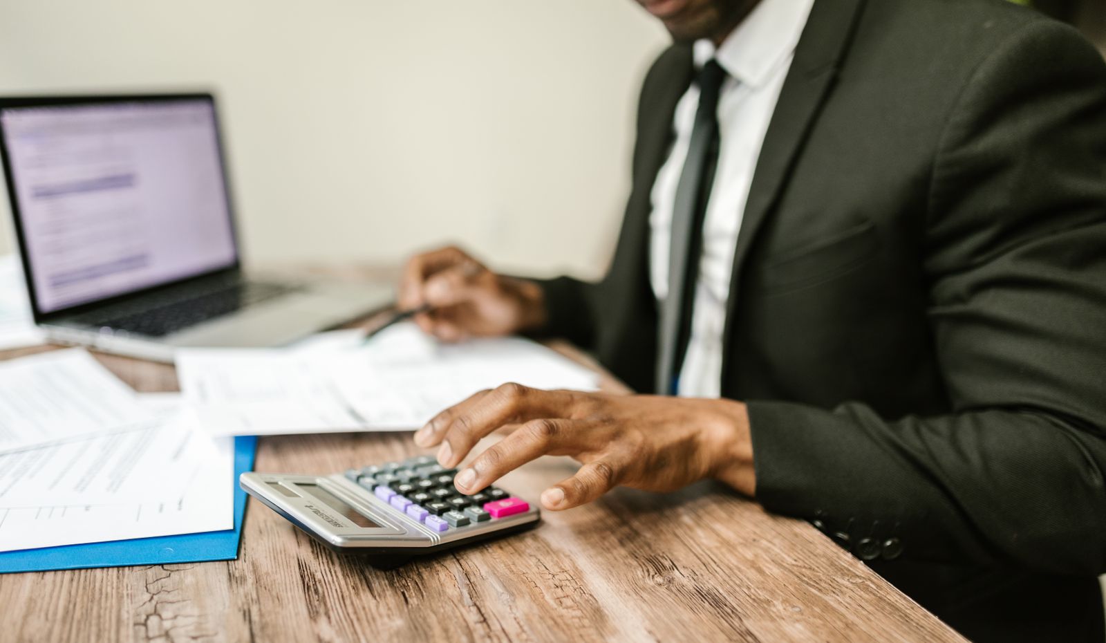 Corporate tax documents and calculator on a desk